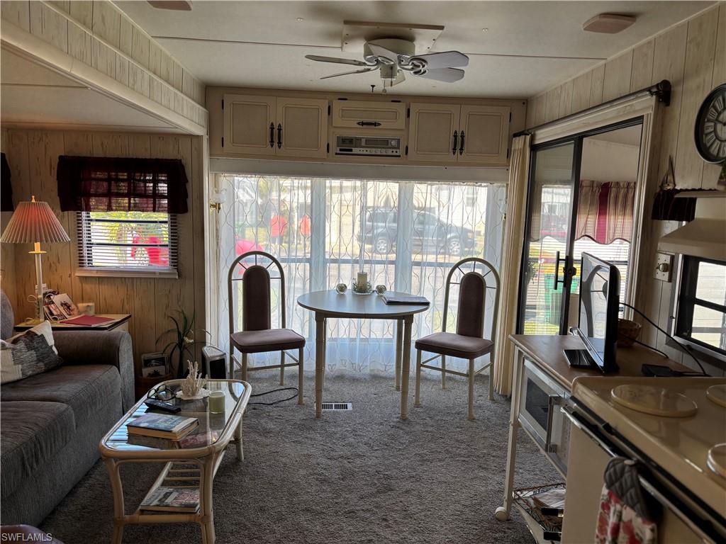 9 Jade Drive, Unit 9J Naples, FL 34114 - Photo 13 of 28 a living room with furniture and a flat screen tv