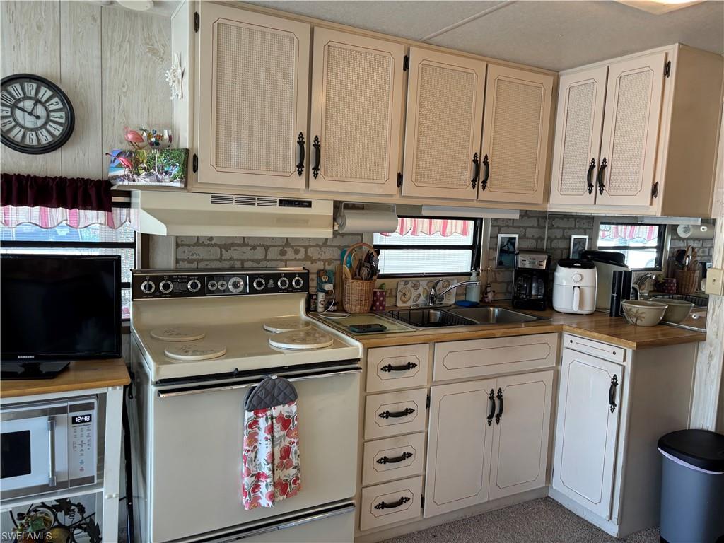 9 Jade Drive, Unit 9J Naples, FL 34114 - Photo 16 of 28 a kitchen with stainless steel appliances granite countertop a stove and a microwave