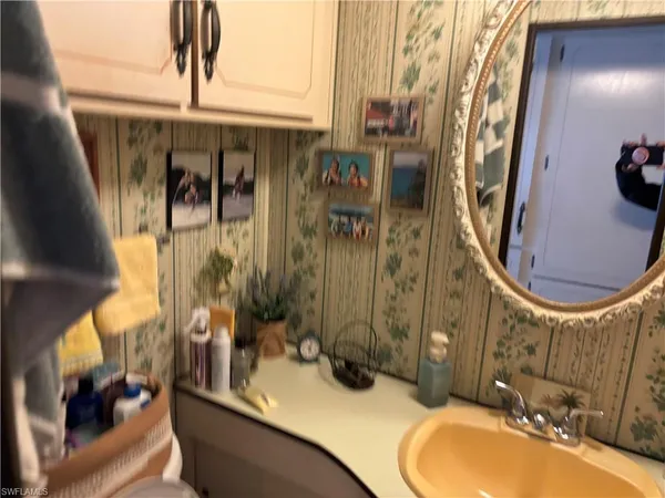 a bedroom with a bed a window and dresser