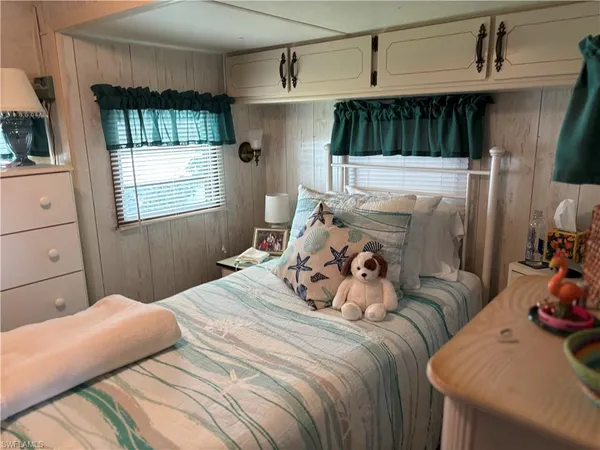 a bedroom with a bed and a flat tv screen