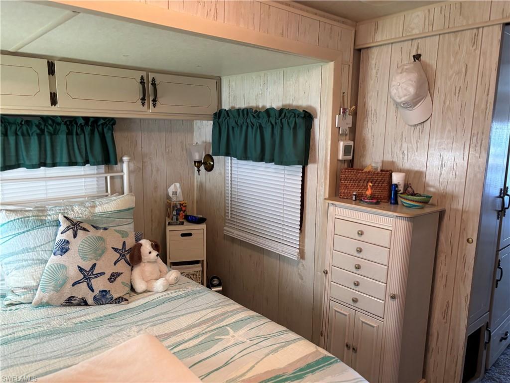 9 Jade Drive, Unit 9J Naples, FL 34114 - Photo 21 of 28 a bedroom with a bed and cabinets