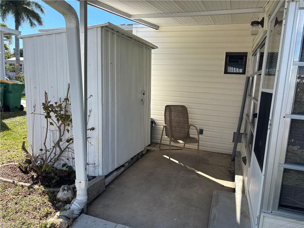 9 Jade Drive, Unit 9J Naples, FL 34114 - Photo 4 of 28 a view of a porch with a table and chairs and potted plants