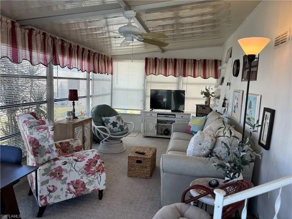 a room with lots of furniture and a chandelier