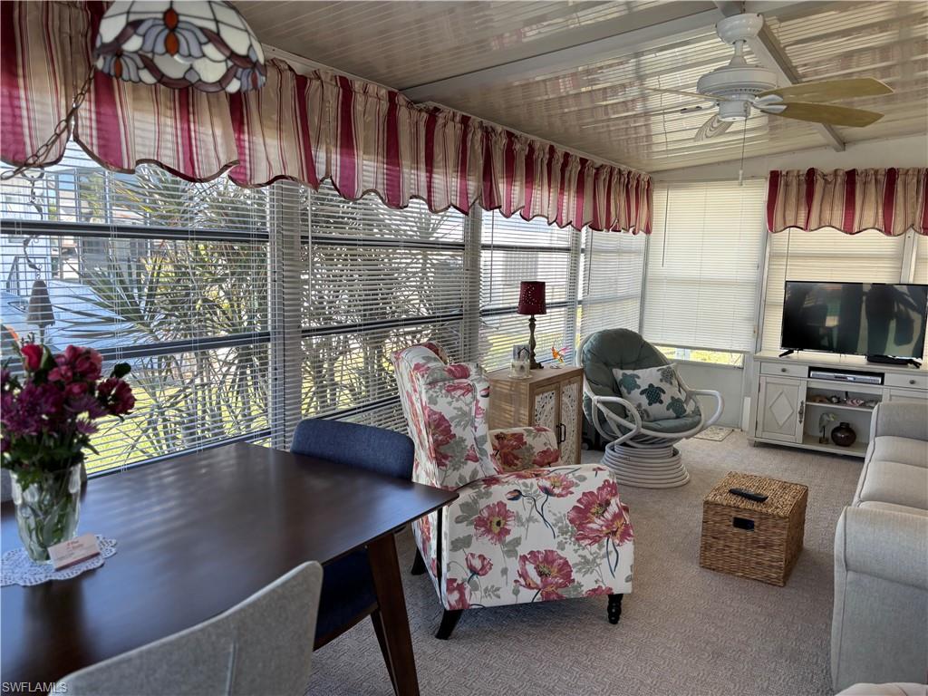 9 Jade Drive, Unit 9J Naples, FL 34114 - Photo 9 of 28 a room with lots of furniture and a chandelier