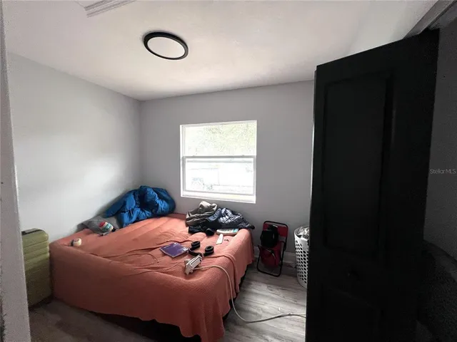 a bedroom with a bed and window