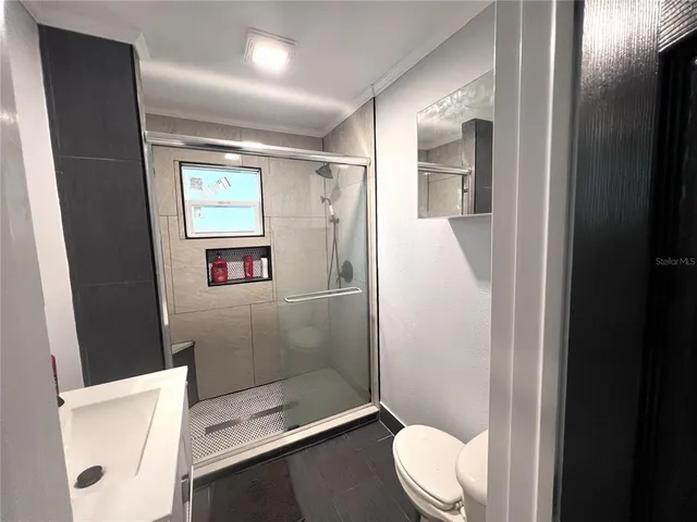 a bathroom with a toilet and a shower