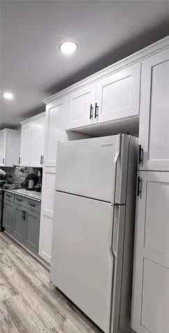 a white refrigerator freezer sitting inside of a kitchen