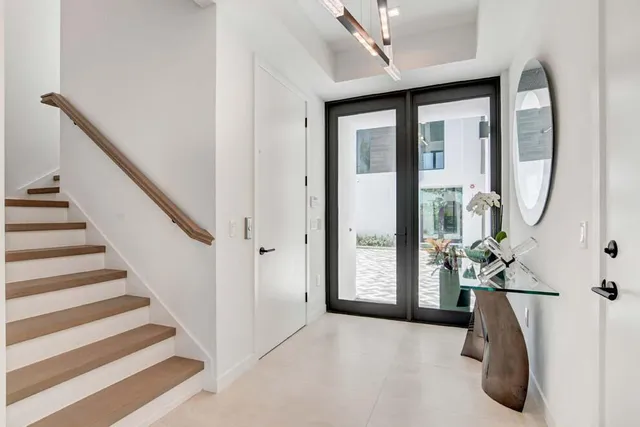 a view of a hallway with dining room and utility room