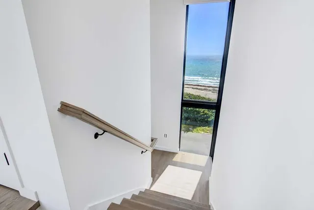 a bed room with a bed television and a large window