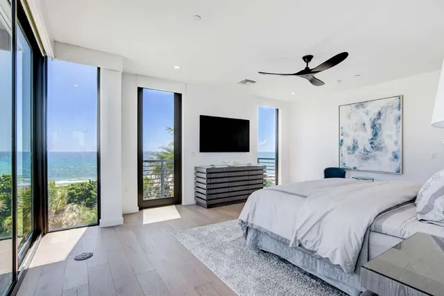 a bedroom with a bed and large window