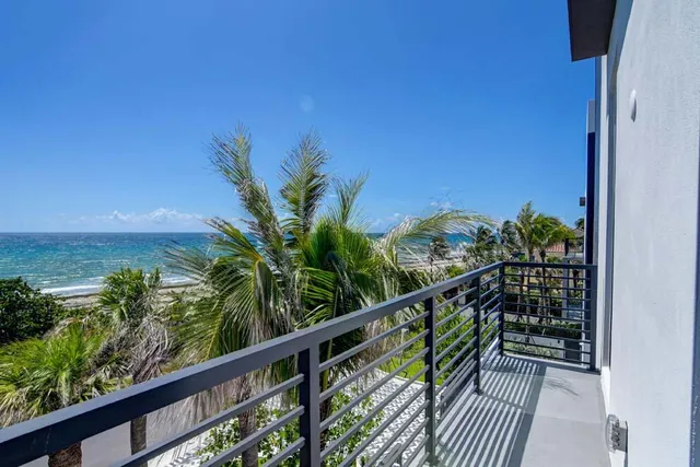 a spacious bedroom with a large bed and a chandelier