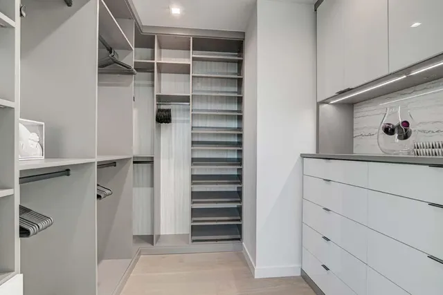 a bathroom with a granite countertop sink a toilet and shower