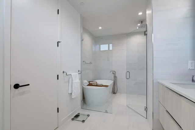 a bathroom with a shower and a sink
