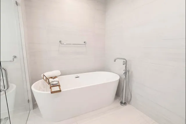 a bedroom with a large bed and a large window