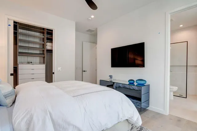 a bedroom with a bed and a flat screen tv