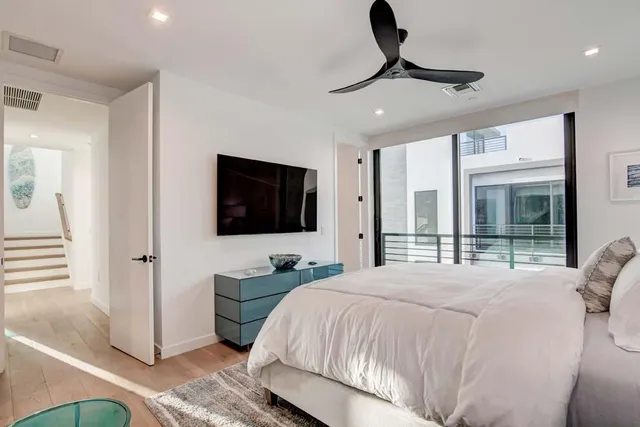 a bedroom with a bed and a flat screen tv