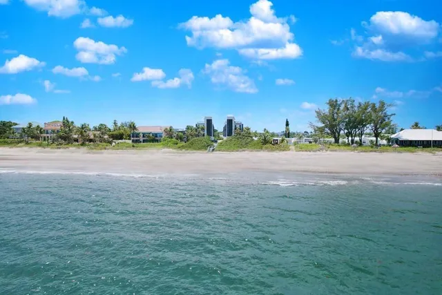 a large white room with a large window and furniture