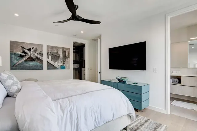 a bathroom with a sink a toilet a mirror and shower