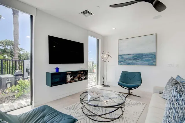 a living room with furniture and a wooden floor