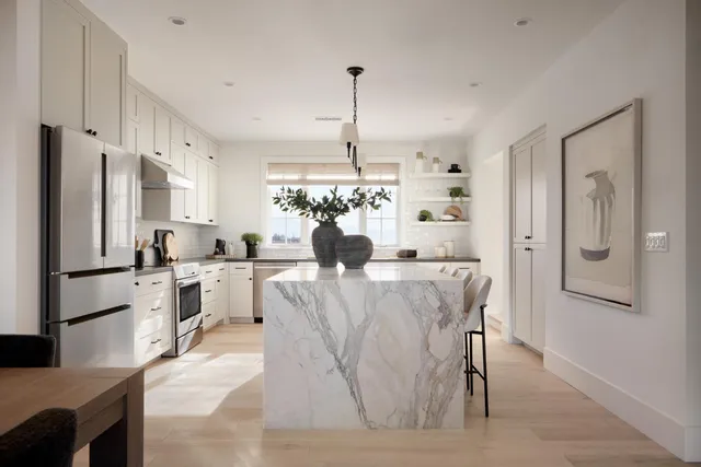 a view of a kitchen with kitchen island a refrigerator a sink dishwasher a dining table and chairs