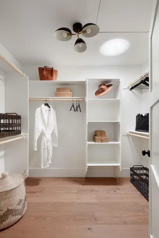 a view of room with a ceiling fan and wooden floor