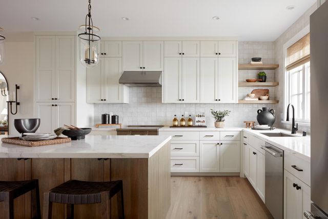 a kitchen with a sink stove and white cabinets