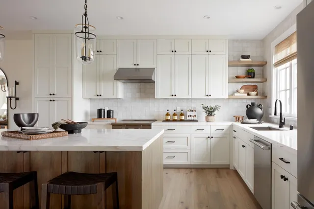 a kitchen with a sink stove and white cabinets