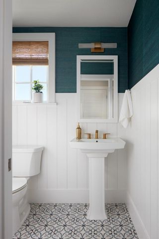 a bathroom with a sink a toilet and mirror