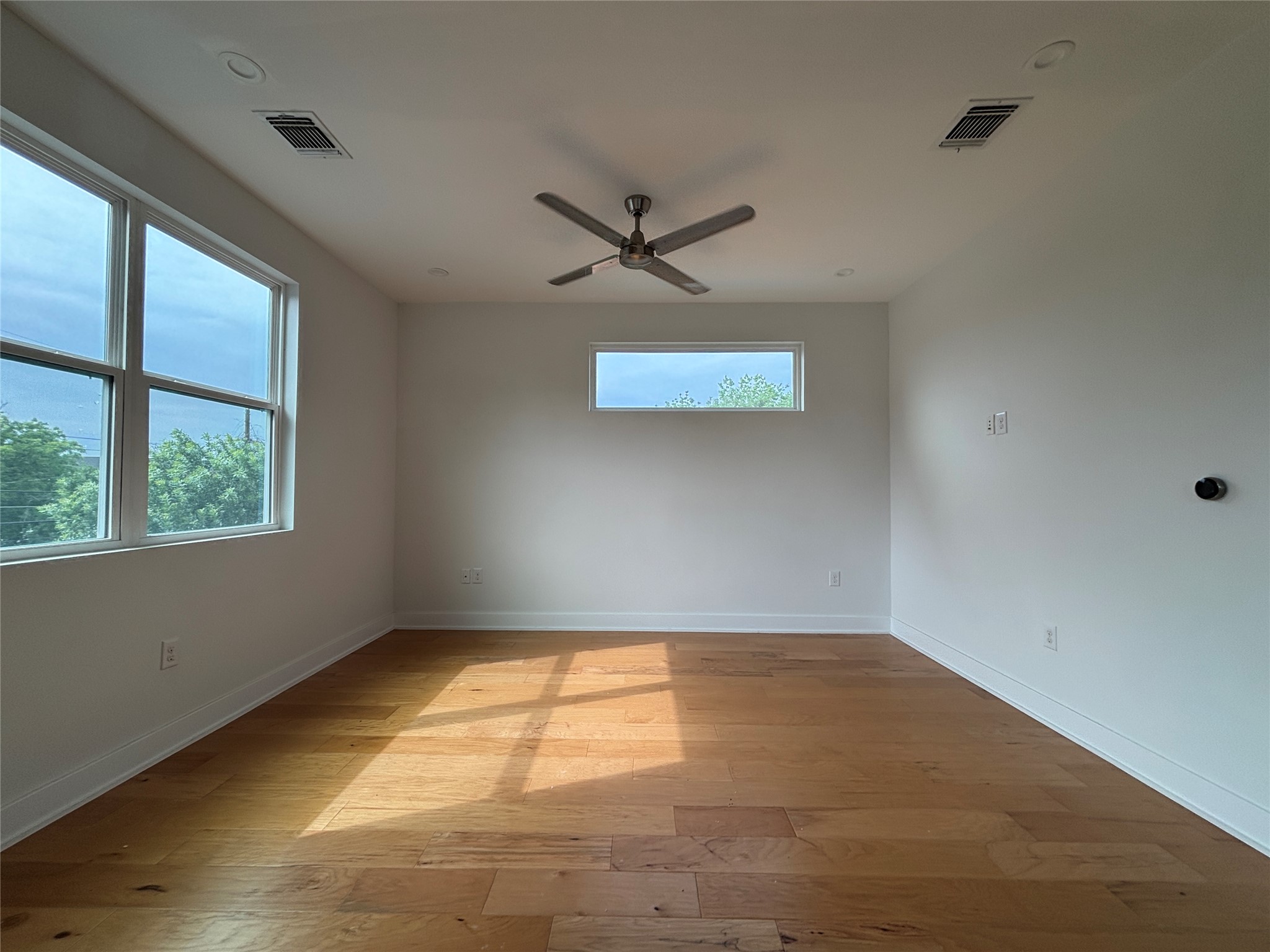 1719 Bunche Road Austin, TX 78721 - Photo 11 of 22 Well-lit room with wood floors and a contemporary ceiling fan awaits your personal touch.
