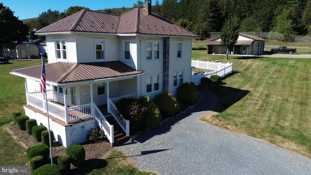 a front view of a house with a garden and porch