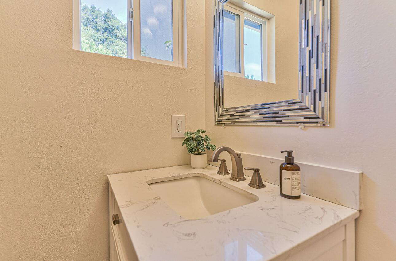 26 Young Drive Salinas, CA 93901 - Photo 19 of 28 a bathroom with a granite countertop sink and a mirror