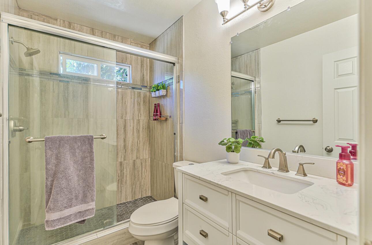 26 Young Drive Salinas, CA 93901 - Photo 24 of 28 a bathroom with a granite countertop sink a toilet and shower