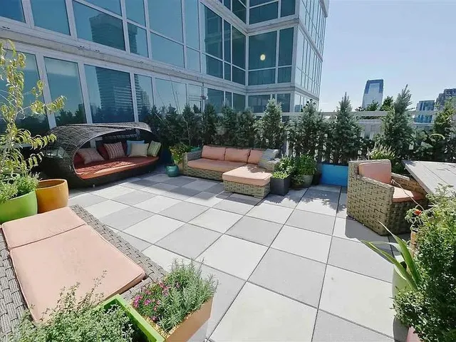a view of a patio with plants and outdoor seating