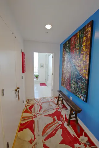 a room with a bed and a painting on the wall