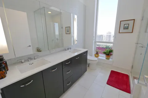 a spacious bathroom with a double vanity sink mirror and a bathtub