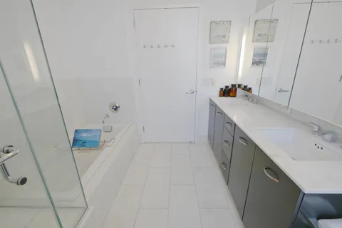 a bathroom with a sink a mirror and shower
