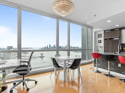 a very nice looking living room with a large window and furniture