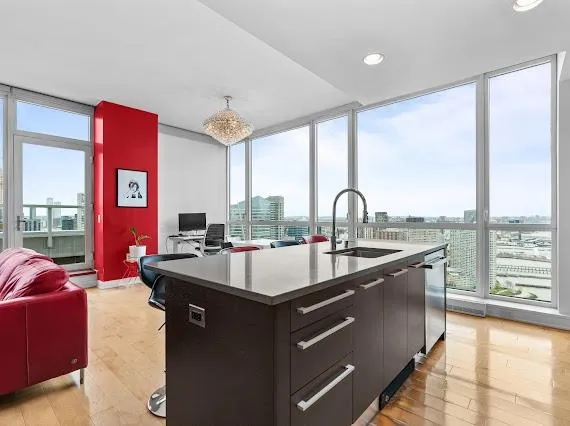 a kitchen with kitchen island a sink and a large window