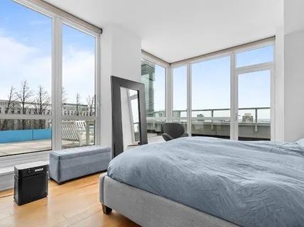 a spacious bedroom with a large bed and a large window