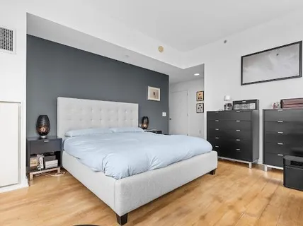 a bedroom with a bed and dresser