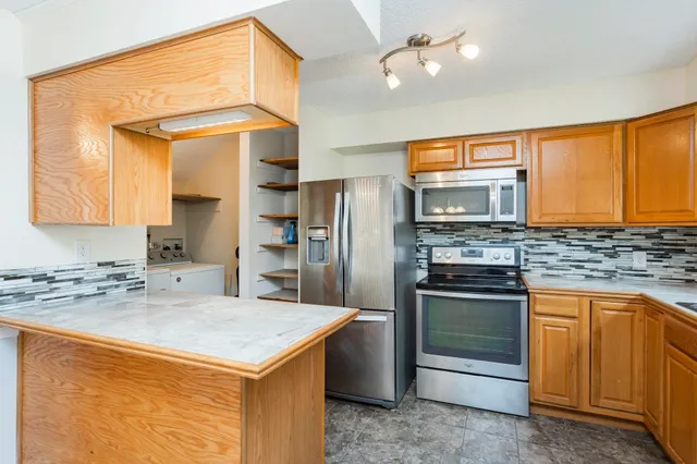 a kitchen with a stove a sink and a refrigerator
