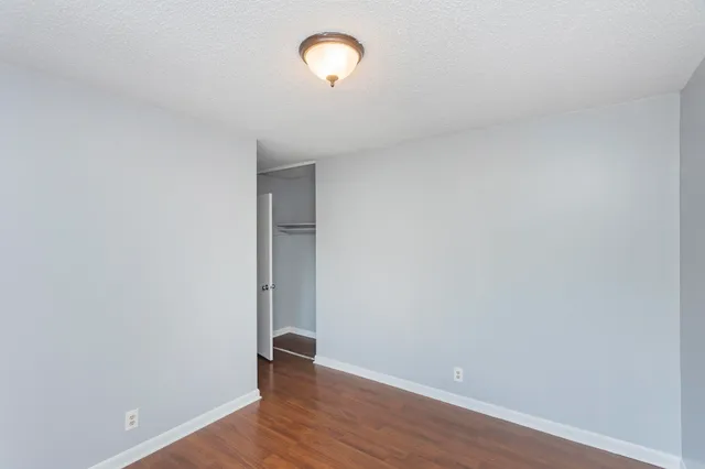 a view of room with wooden floor