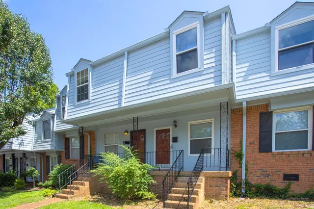 front view of a brick house with a large windows