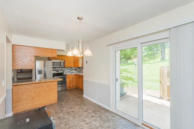 a kitchen with a refrigerator and a stove