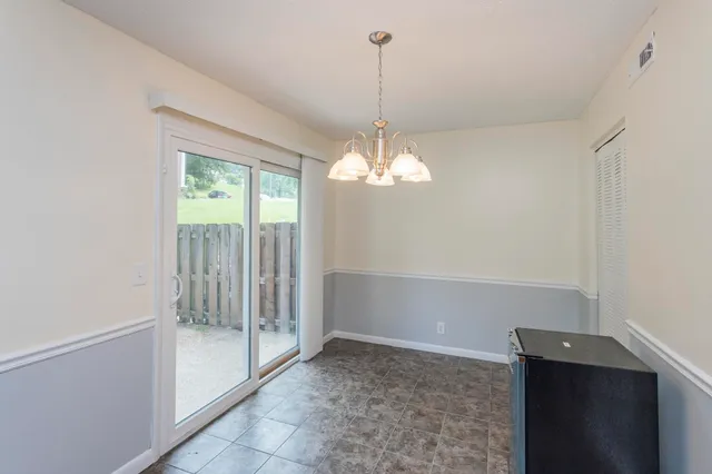a view of a chandelier in big room and chandelier fan