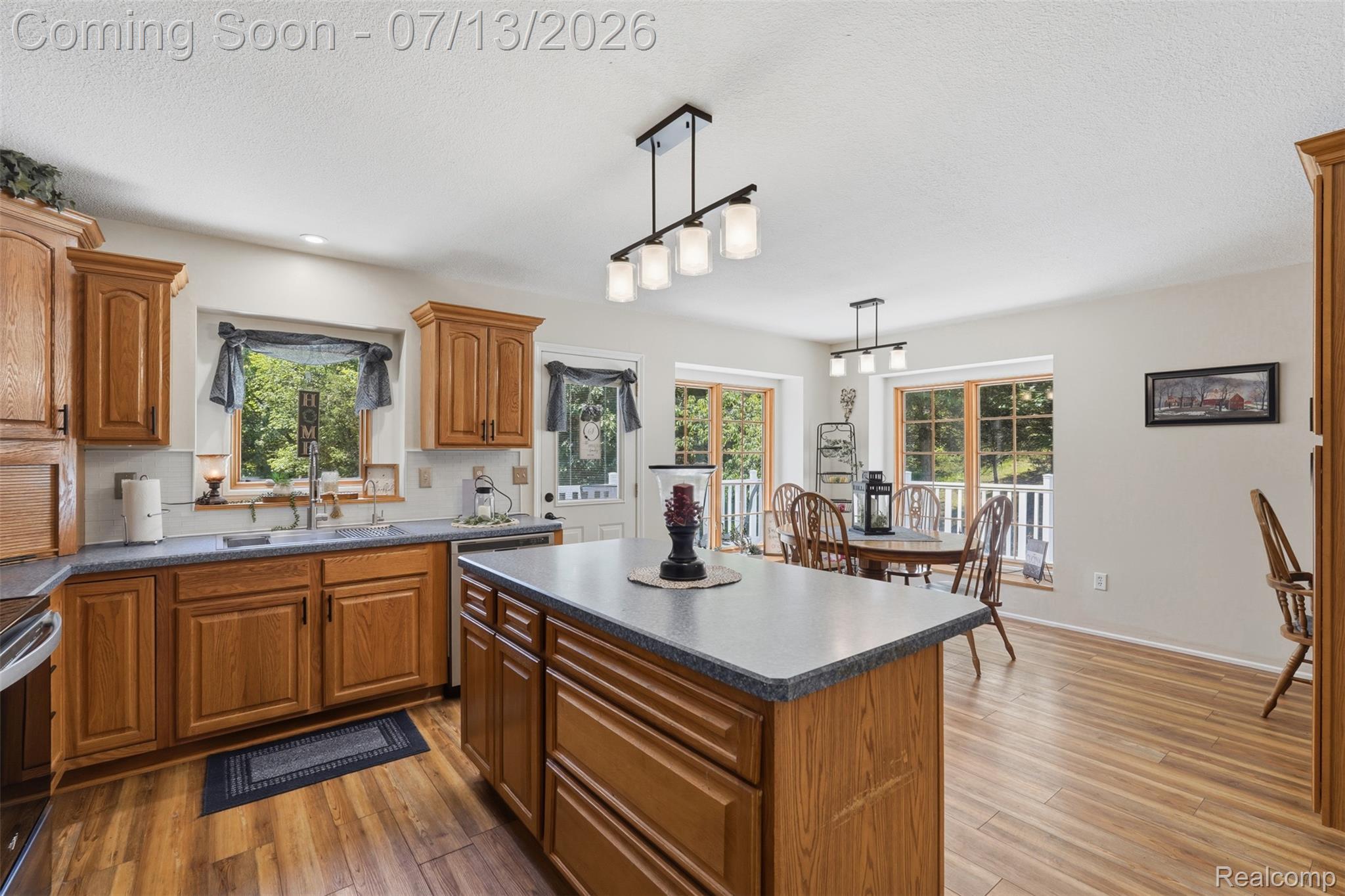 10525 Antcliff Road Brooklyn, MI 49230 - Photo 12 of 80 Kitchen featuring new laminate flooring and panoramic views from the wraparound porch