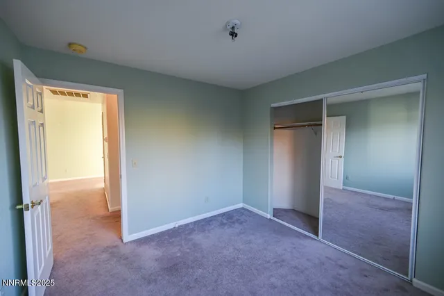 a view of an empty room and a window