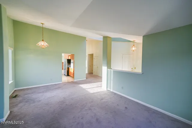 a view of empty room with a mirror