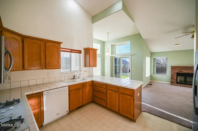a kitchen with sink and refrigerator
