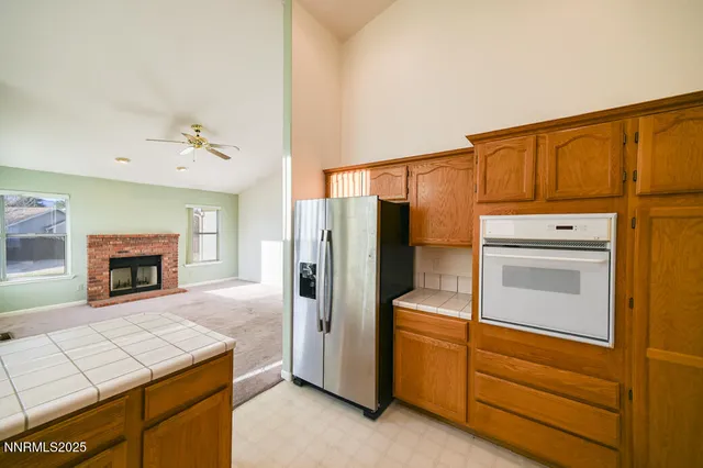 a kitchen with a refrigerator sink and cabinets